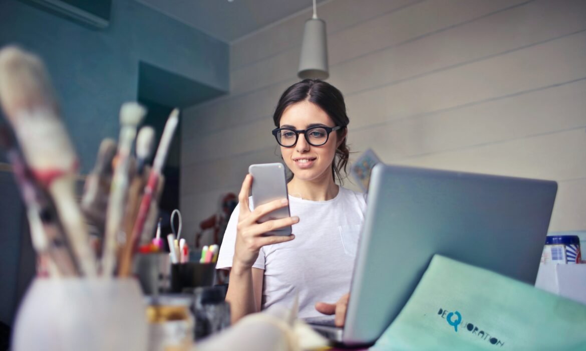 woman in white shirt using smartphone